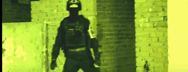 a man in a helmet stands in front of a yellow wall