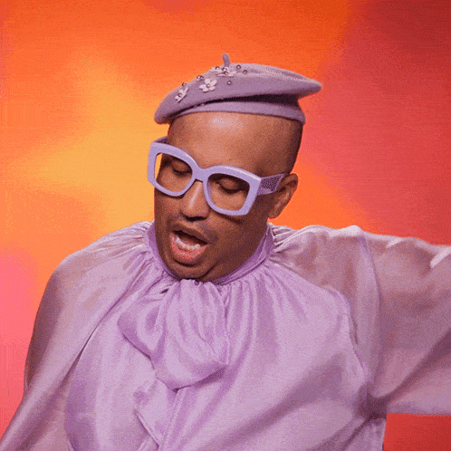 a man wearing glasses and a purple shirt with the word swish written on it