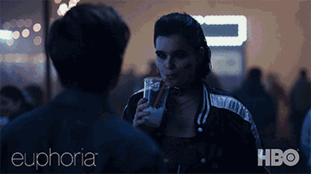 a poster for euphoria shows a woman drinking from a glass with a straw