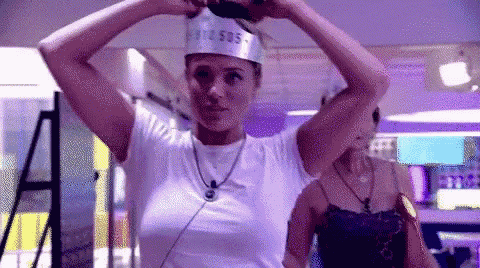a woman wearing a white t-shirt and a silver crown on her head .