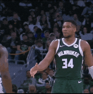 a basketball player wearing a green milwaukee jersey with the number 34 on it