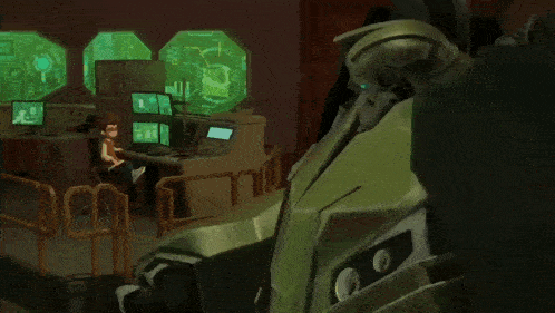 a robot with blue eyes is standing in front of a monitor