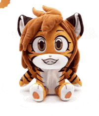 a stuffed tiger is sitting on a white surface .