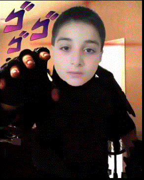 a young boy is wearing a black turtleneck and holding a black glove in front of his face .