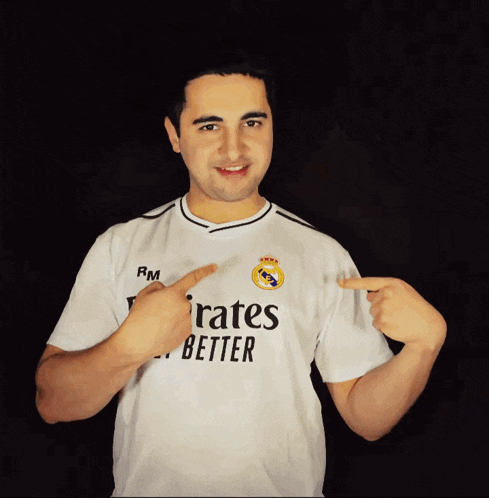 a man wearing a shirt that says " emirates better "