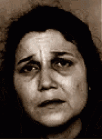 a black and white photo of a woman with a sad look on her face