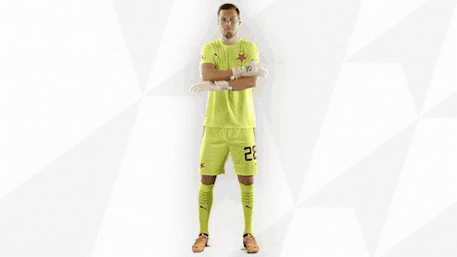 a soccer player wearing a yellow jersey with the word etoro on it
