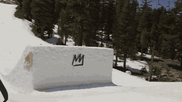 a block of snow has the letter m written on it
