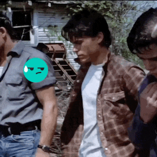 a man in a plaid shirt has a green smiley face on his shoulder