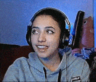 a girl wearing headphones and a sweatshirt that says wlf