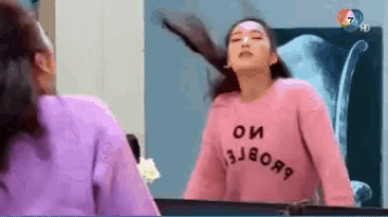 a woman wearing a pink sweater that says oи 3j8oя9