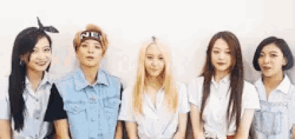 a group of girls standing next to each other with one wearing a bandana that says ne