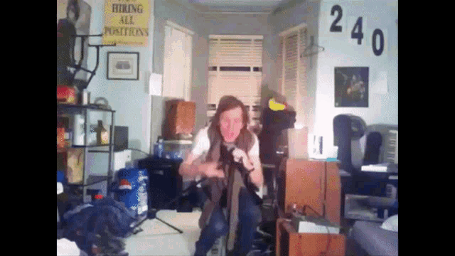 a man in a room with a sign that says " hiking all positions "