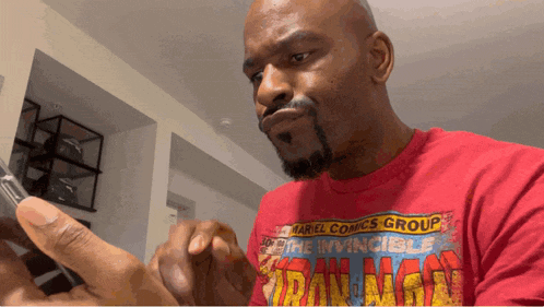 a man wearing a red t-shirt that says marvel comics group