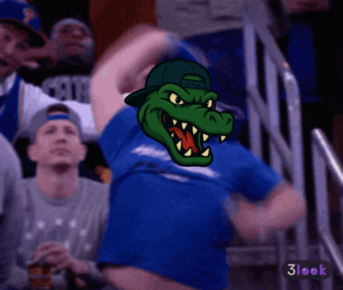 a man wearing a blue shirt with a crocodile on his shirt