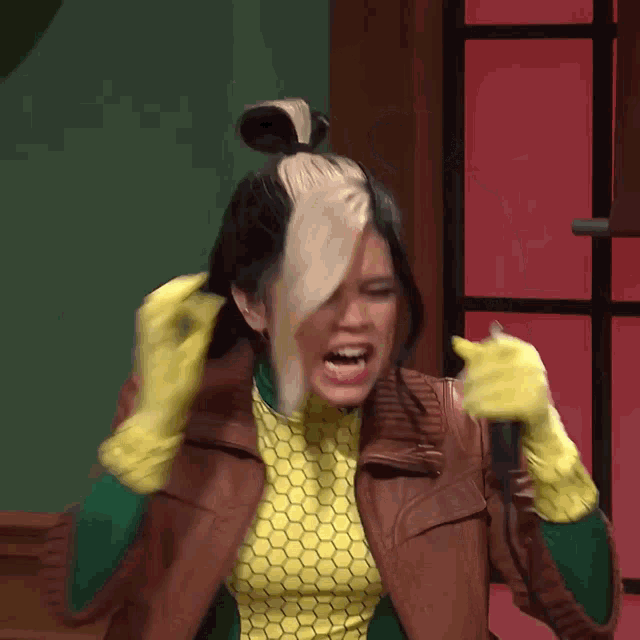 a woman in a rogue costume is holding a microphone in her hand