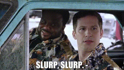 two men are sitting in a car and one of them is saying , `` slurp , slurp . ''