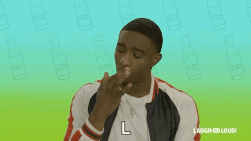 a man is holding something in his mouth and says l.