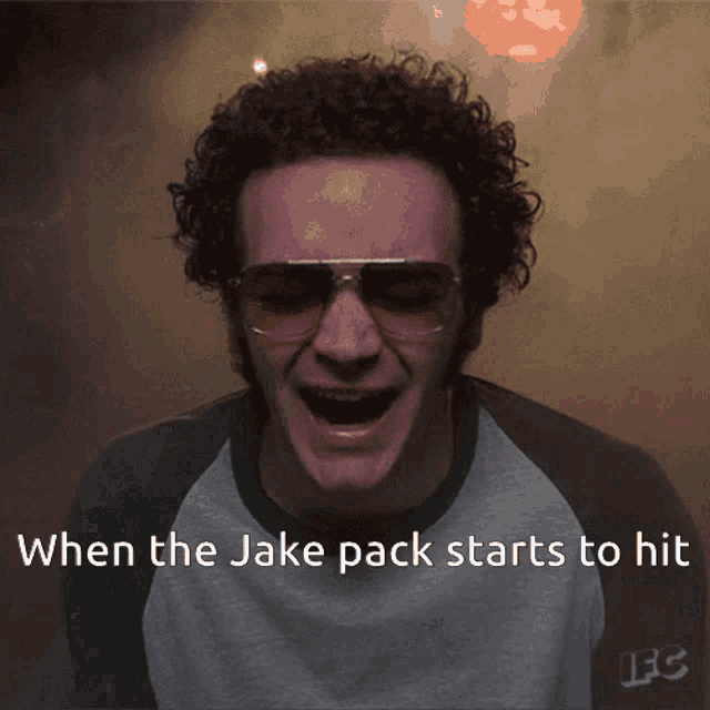 a man with curly hair wearing sunglasses and a shirt that says lfc