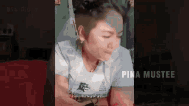 a woman wearing a white shirt with the word pina mustee on the bottom right
