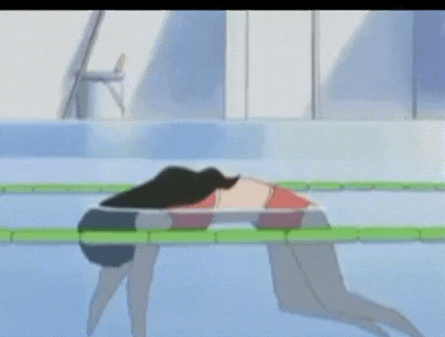 a girl is laying in a swimming pool with a green board