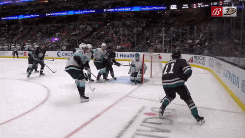 a hockey game is being played in a stadium sponsored by pacific power bank