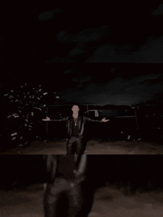 a man in a leather jacket is holding a piece of paper with the word lil bitch written on it