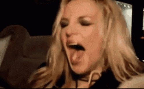 a close up of a woman 's face with her mouth open .