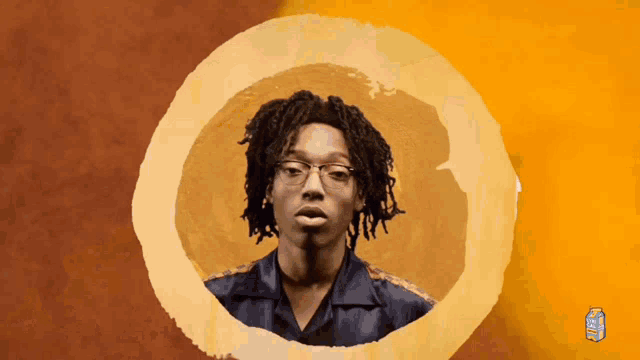 a man with glasses is surrounded by a circle and a can of juice