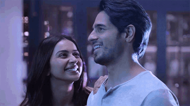 a man and a woman are smiling at each other