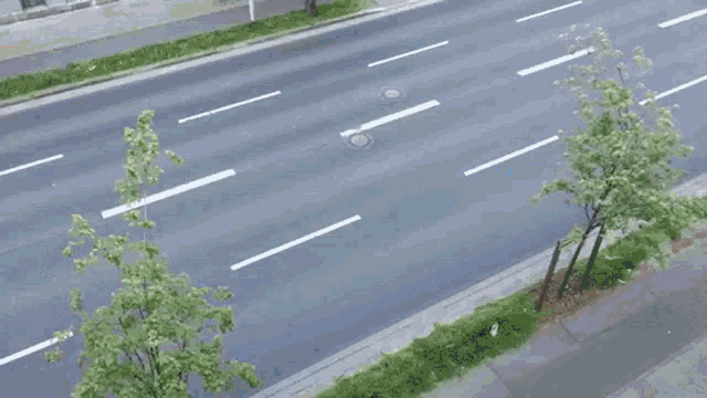 an aerial view of a car driving down a street with a cartoon character on the side of it