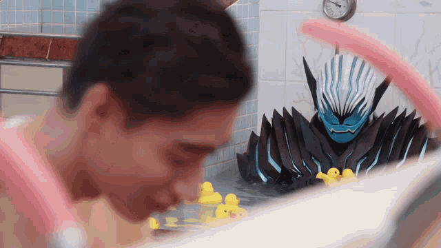 a man in a bathtub with rubber ducks in it