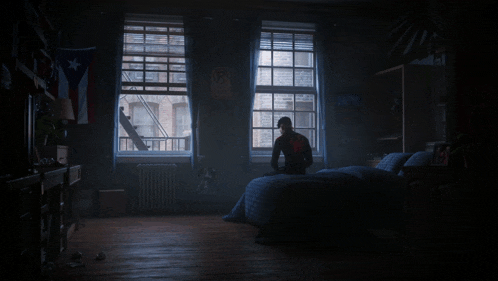 a dark room with a bed and a window with a sign that says r.i.p.