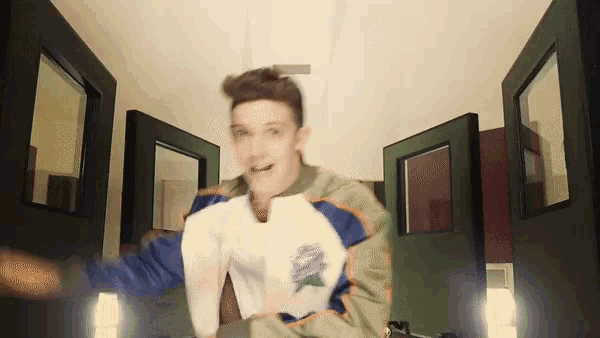 a young man wearing a jacket that says ' sydney ' on it