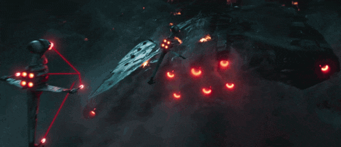 a helicopter is flying through the air with a red light behind it