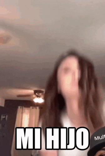 a blurry picture of a woman with the words " mi hijo " on it
