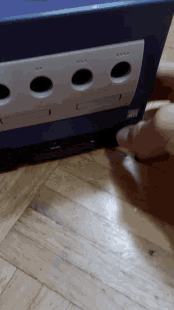 a person is playing a video game on a nintendo gamecube