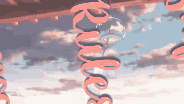a wind chime is hanging from a ceiling with the word rms written on it