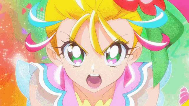 a close up of a girl 's face with a pink and blue outfit