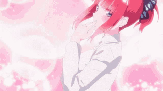 a girl with red hair and blue eyes is blowing pink petals in the air .