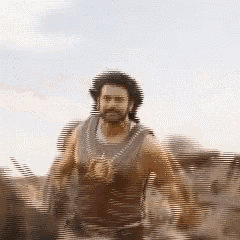 a blurry picture of a man with a beard walking in the desert
