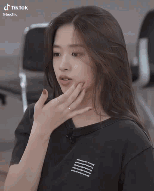 a woman wearing a black shirt that says tik tok on the bottom