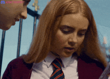 a girl in a school uniform is looking at a piece of paper with a discord logo in the corner