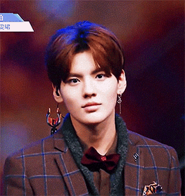 a young man in a plaid suit and bow tie