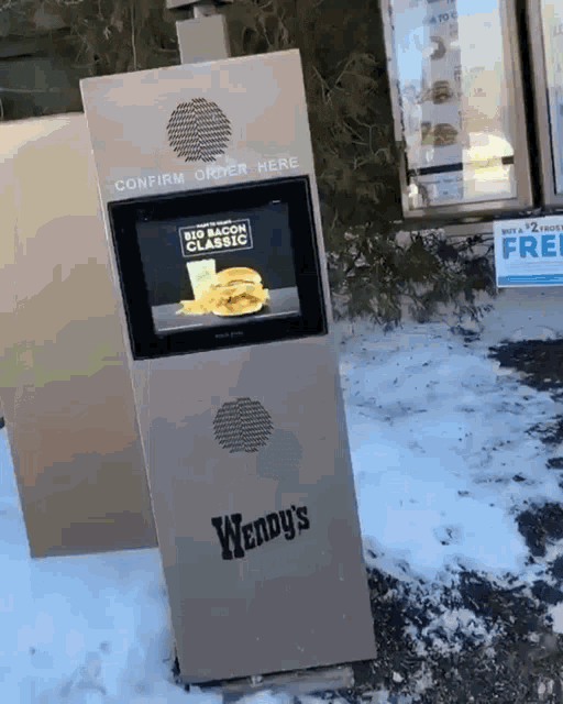 a wendy 's kiosk displays a big bacon classic hamburger