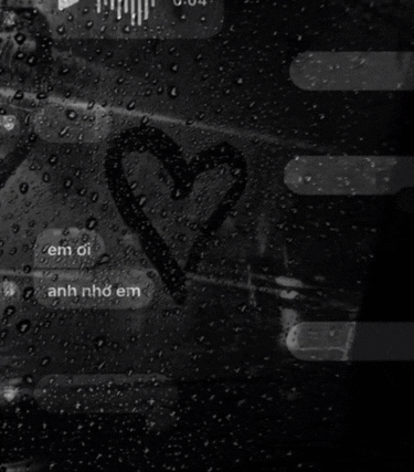 a black and white photo of a heart drawn on a glass
