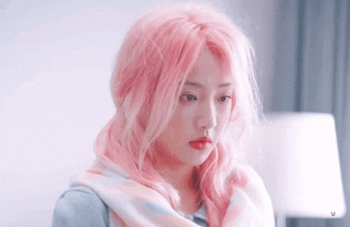 a girl with pink hair and a scarf around her neck