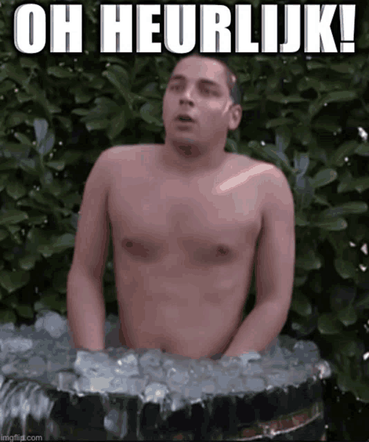 a shirtless man is sitting in a tub of ice with the caption oh heerlijk