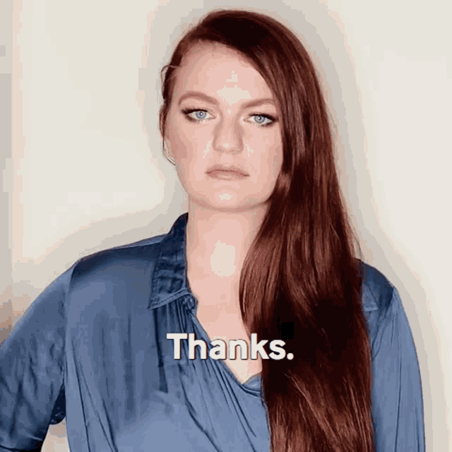 a woman in a blue shirt says thanks in white letters