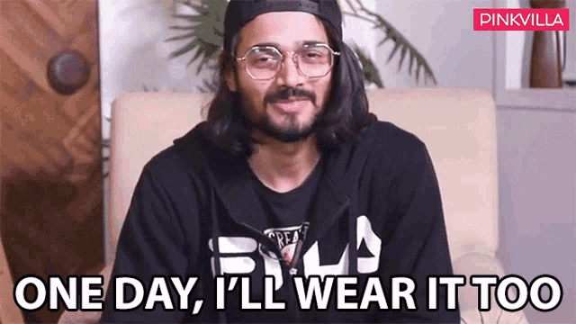 a man wearing glasses and a black hoodie says one day i 'll wear it too